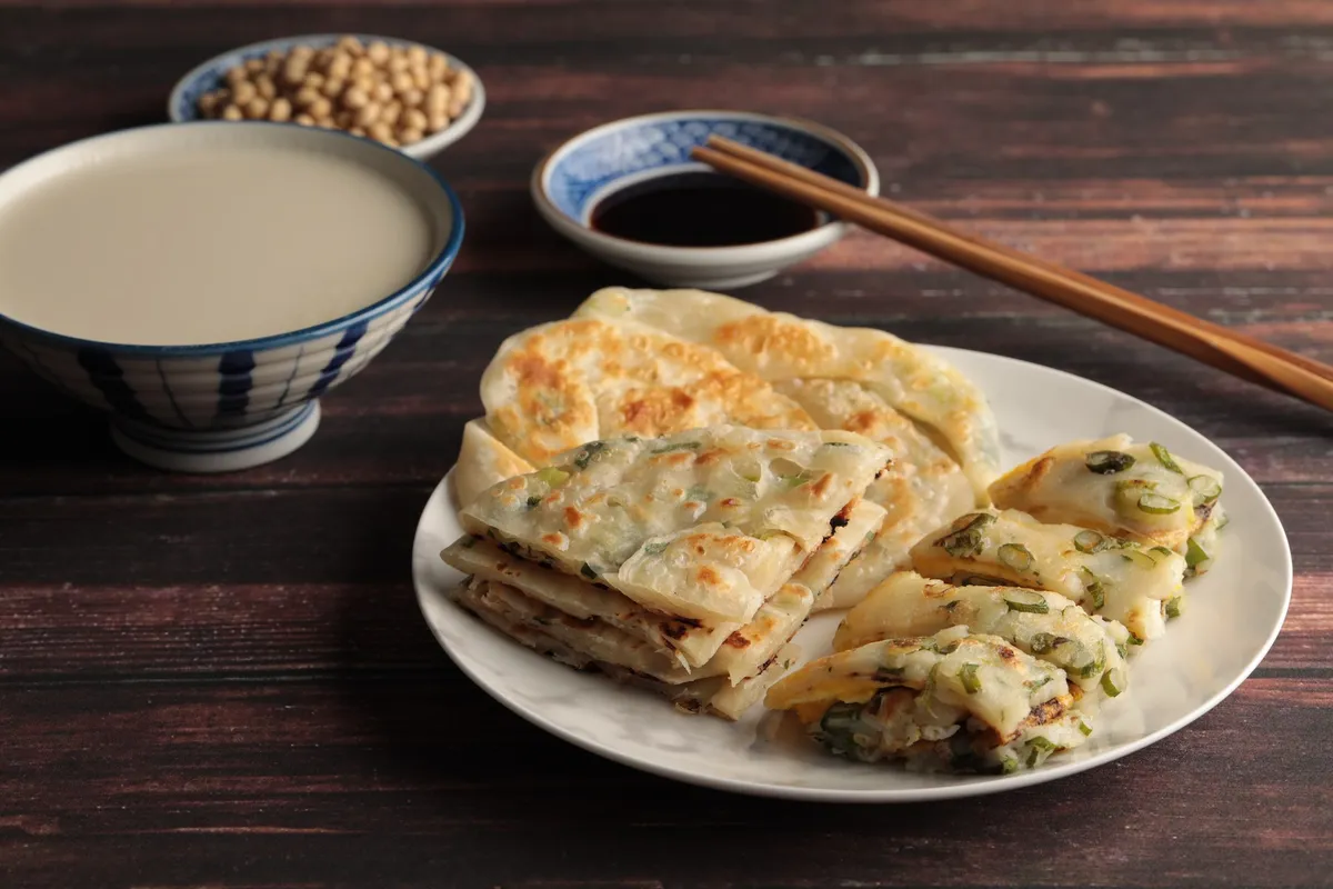 En la Clase de Desayuno Tradicional Taiwanés, harás desde cero los panqueques de cebolleta de múltiples capas. Además, aprenderás los secretos para hacer el tierno y suave Dan Bing. ¡Incluso la leche de soja se hará a partir de granos de soja! Aprovecha la oportunidad para e